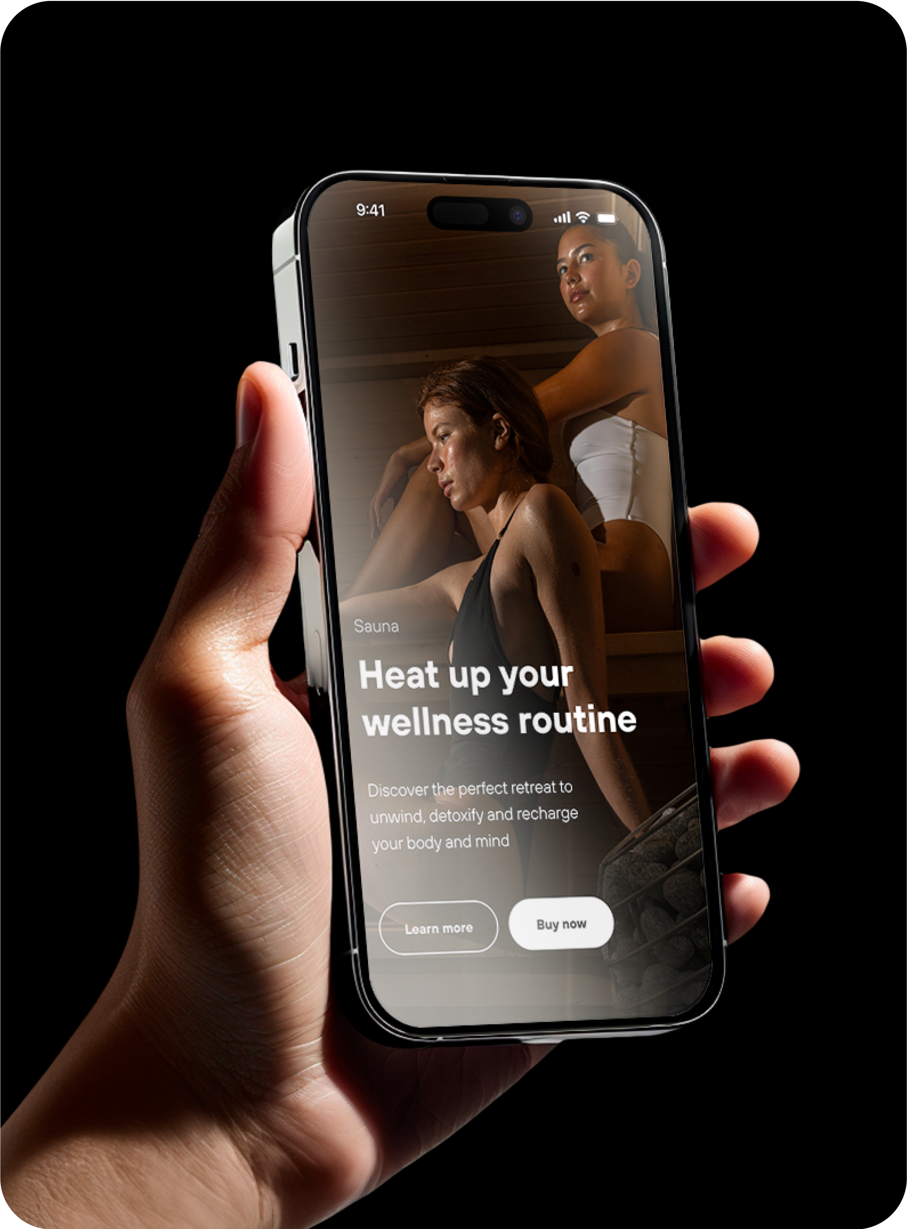 Wellness brand website design. Hand holding a smartphone displaying a sauna wellness mobile screen with two women relaxing in a sauna, accompanied by the text "Heat up your wellness routine."